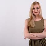 Young beautiful British woman with blond hair against white background